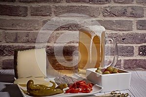 Cheese board next to a beer