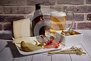 Cheese board next to a beer