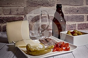 Cheese board next to a beer