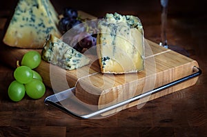 Cheese board stilton mature blue mouldy and grapes photo