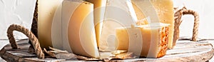 Cheese board of various types of soft and hard cheese. spanish manchego cheese, International dairy delicacies. Long banner format