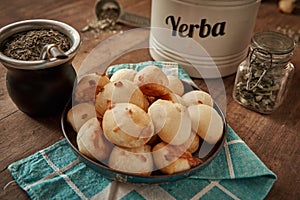 Cheese bread called chipa whit Mate tea cup and yerba mate dried leaves photo