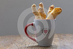 Cheese bread in the form of chopsticks in a mug