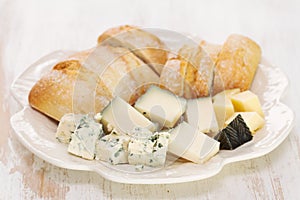 Cheese with bread on white dish