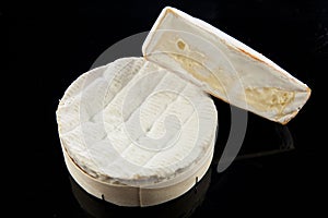 Cheese brie isolated on black background. camambert food