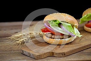 Cheese burger with grilled meat, cheese, tomato, on craft paper