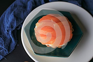 Cheese cake decorated with Mayongchid or plum mango on dark background.