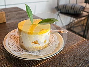 cheese cake with mango in side on a wooden table