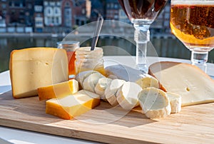 Cheese collection, Belgian abbey cheeses made with brown trappist beer and fine herbs and view on Maas river in Dinant, Wallonia,