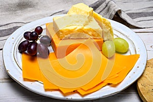 Cheese collection, blocks and slices of yellow and matured english cheddar cheese