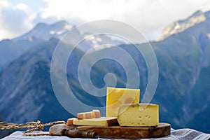 Cheese collection, French beaufort, abondance, emmental, tomme de savoie cheeses served outdoor in Savoy region, with Alpine