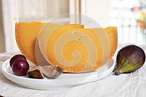 Cheese collection, French cheese mimolette made from cow milk served with fresh figs