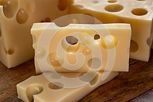 Cheese collection, french hard cheese with holes emmentaler close up