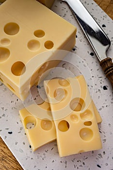 Cheese collection, french hard cheese with holes emmentaler close up