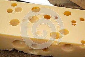 Cheese collection, french hard cheese with holes emmentaler close up