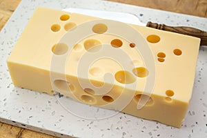 Cheese collection, french hard cheese with holes emmentaler close up