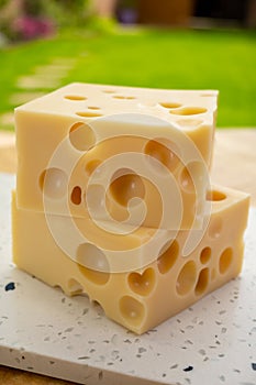 Cheese collection, french hard cheese with holes emmentaler close up