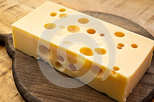 Cheese collection, french hard cheese with holes emmentaler close up