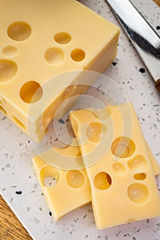 Cheese collection, french hard cheese with holes emmentaler close up