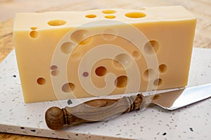 Cheese collection, french hard cheese with holes emmentaler close up