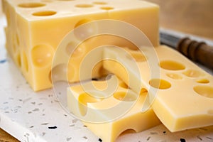 Cheese collection, french hard cheese with holes emmentaler close up