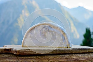 Cheese collection, French reblochon de savoie cheese served outdoor in Savoy region, with Alpine mountains peaks on background