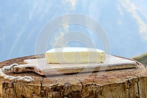 Cheese collection, French reblochon de savoie cheese served outdoor in Savoy region, with Alpine mountains peaks on background