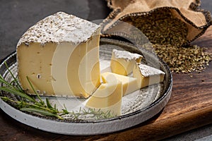 Cheese collection, French tomme cailladou cheese made with aromatic herbs of provence rosematy, thyme,  origano