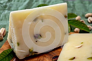 Cheese collection, fresh Italian pecorino cheese made from sheep milk filled with pistachio nuts from Bronte, Sicily photo