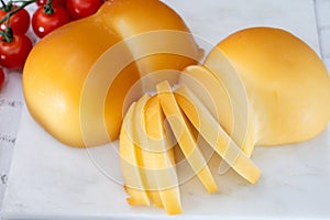 Cheese collection, Italian cheese scamorza, caciocavallo, provolone made from cow milk in South Italy yellow smoked cheese