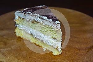 Cheese cream cake served on a wooden dish