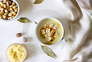 Cheese cream soup on a white background. White bread croutons. Ingredients