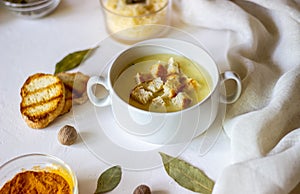 Cheese cream soup on a white background. White bread croutons. Ingredients