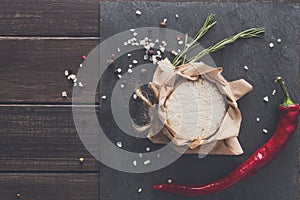 Cheese delikatessen with chili on black stone, brie camembert photo