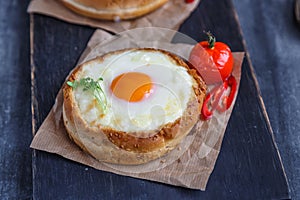 Cheese filled brioche with egg yolk and baked tomato