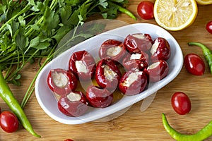 Cheese filled cherry peppers on wooden background. photo