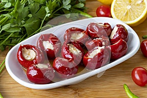 Cheese filled cherry peppers on wooden background. photo