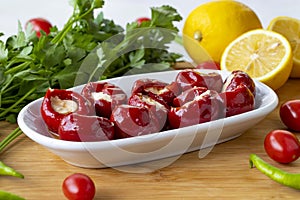 Cheese filled cherry peppers on wooden background. photo