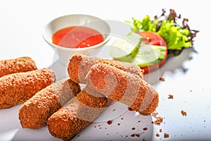 CHEESE FINGERS with sauce and salad served in a dish side view on grey background
