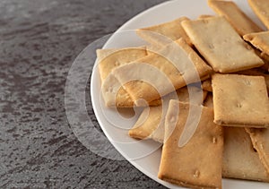 Cheese flavor crostini crackers on a white plate