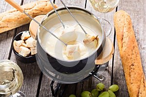 Cheese fondue with bread wine and grape