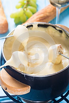 Cheese fondue with bread wine and grape