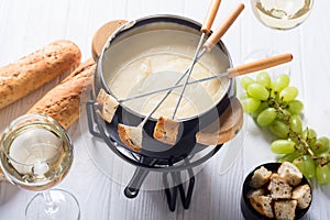 Cheese fondue with bread wine and grape