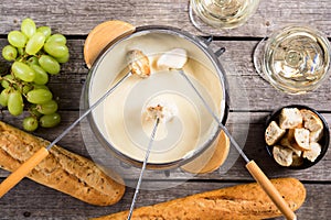 Cheese fondue with bread wine and grape