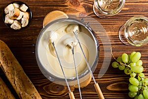 Cheese fondue with bread wine and grape