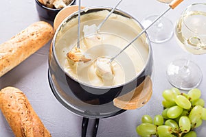 Cheese fondue with bread wine and grape