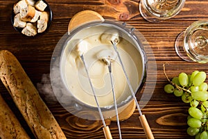 Cheese fondue with bread wine and grape