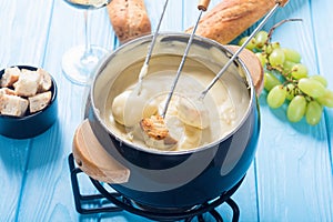 Cheese fondue with bread wine and grape