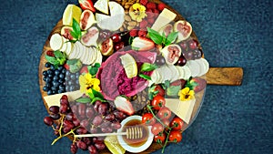 Cheese and fruit charcuterie dessert grazing platter on wooden board. photo