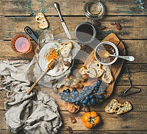 Cheese, fruit and wine set over rustic wooden background